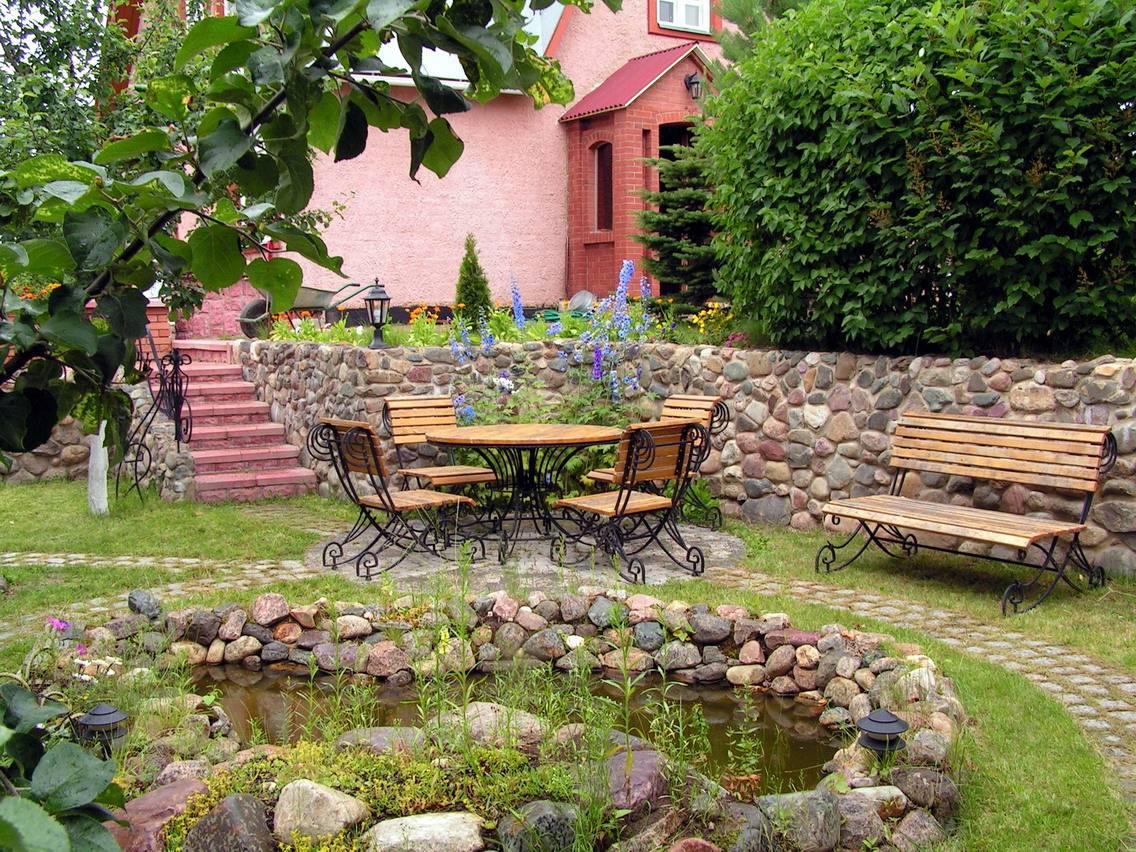 large medium-sized conifers in the landscaping of the cottage