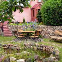 unusual landscape decor of a summer cottage in the English style with trees picture