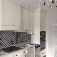 beautiful interior of a white kitchen with a touch of green photo