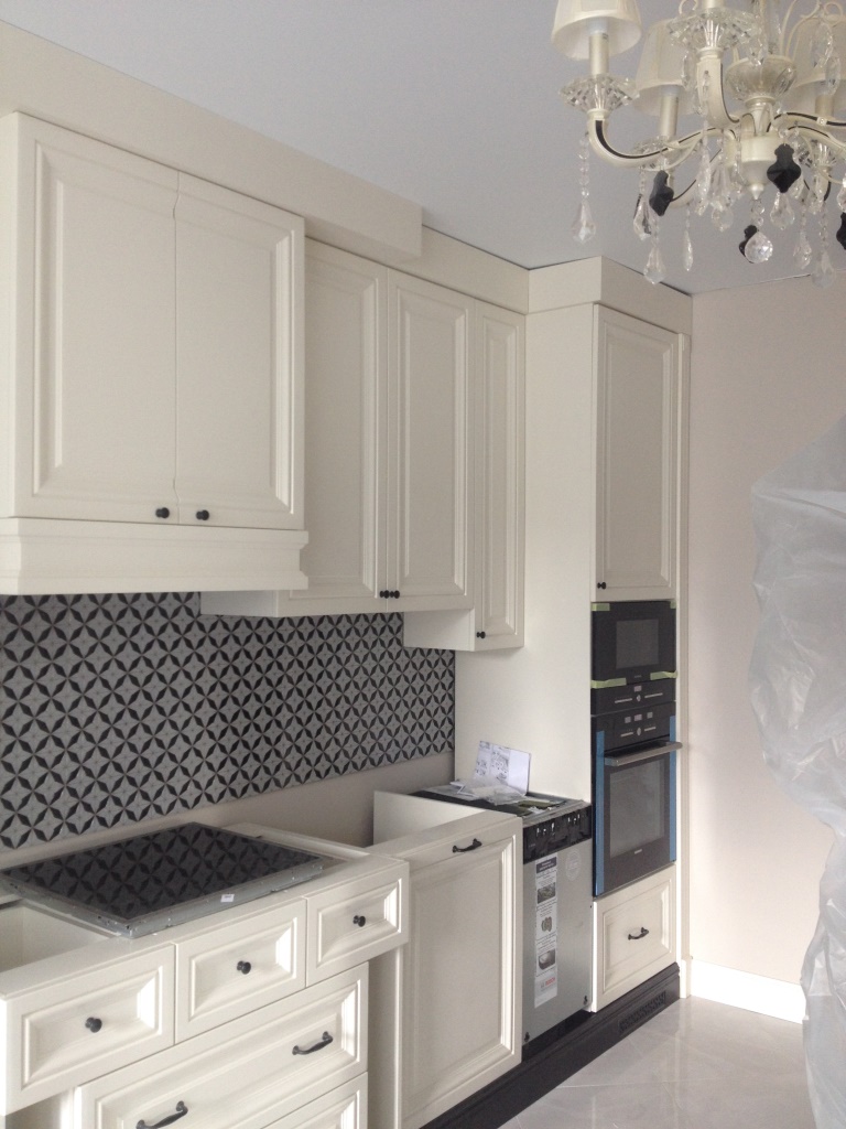 bright interior of a white kitchen with a touch of beige