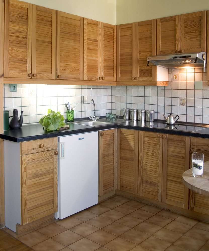 a small refrigerator in the decor of the kitchen in gray