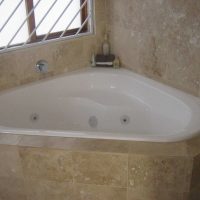 version of the modern bathroom interior with corner bathtub photo