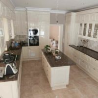 An example of a bright kitchen design in a classic photo style