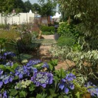 An example of a bright front garden design in a private courtyard