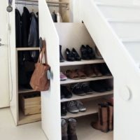 cabinets and shelves under the stairs