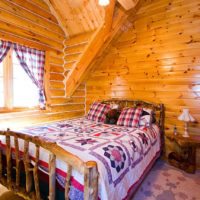 bedroom in a wooden house with curtains