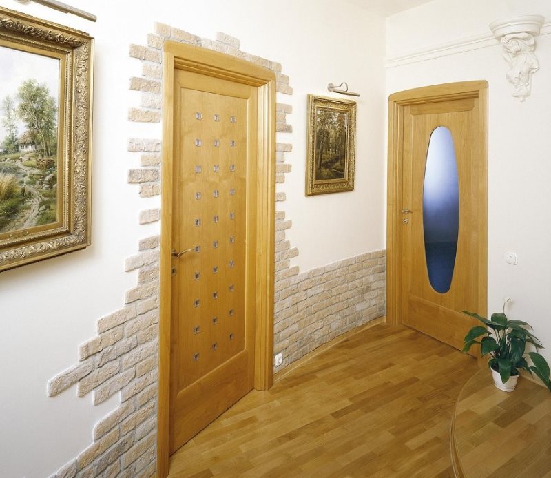 Stone trim the entrance door and the bottom of the wall in the hallway