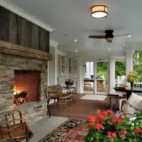 Fireplace in the interior of the cottage veranda