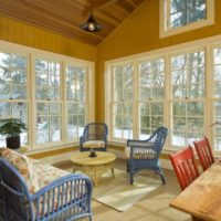 Glazing of a country veranda with a high ceiling