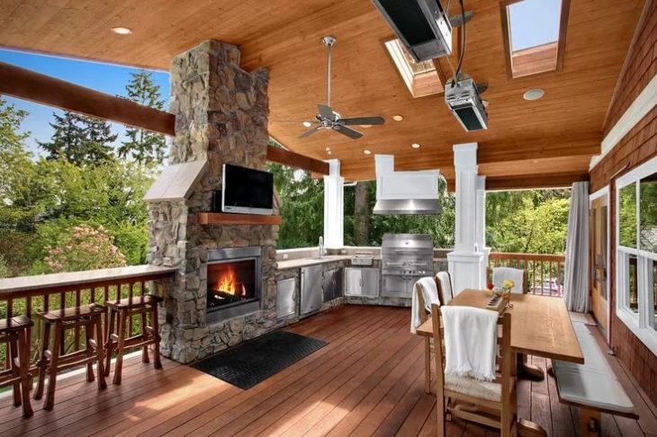 Fireplace with burning wood on the summer terrace