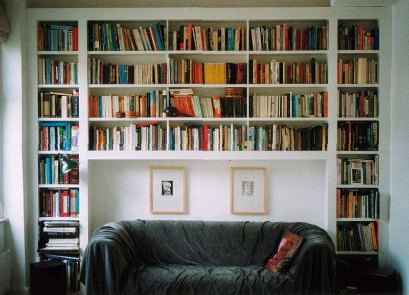 Mini library over the sofa in the living room