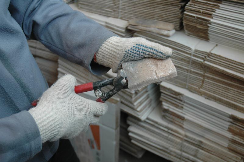 Processing a slice of decorative stone before fixing it to the hallway wall