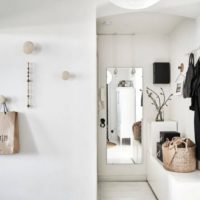 Mirror and hanger on the wall of a modern hallway