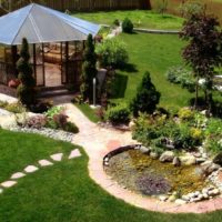 Garden furniture and homemade pond in the garden