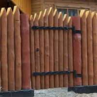 Un recinto di pali di legno intorno a un terreno giardino