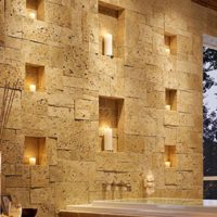 Niches illuminated in the stone wall of the hallway