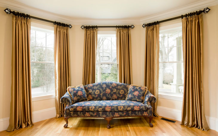 Windows in the living room with curtains on the rings