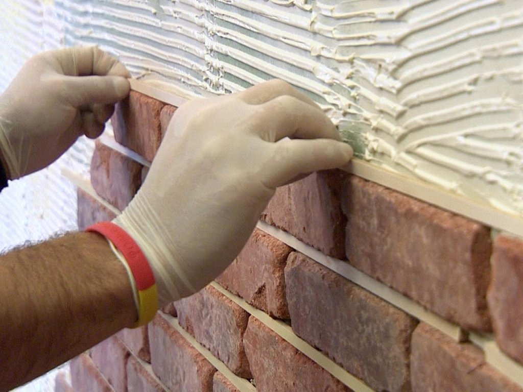 Laying decorative stone on the wall in the hallway