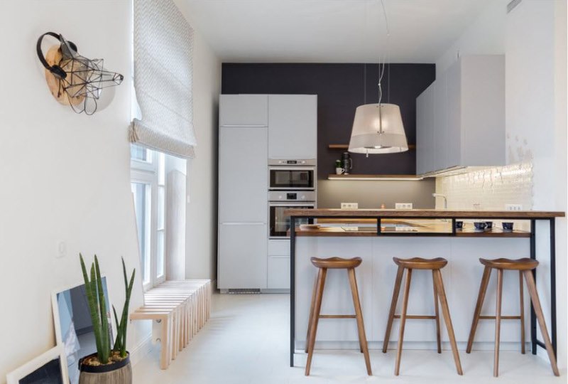 White kitchen with a dark wall