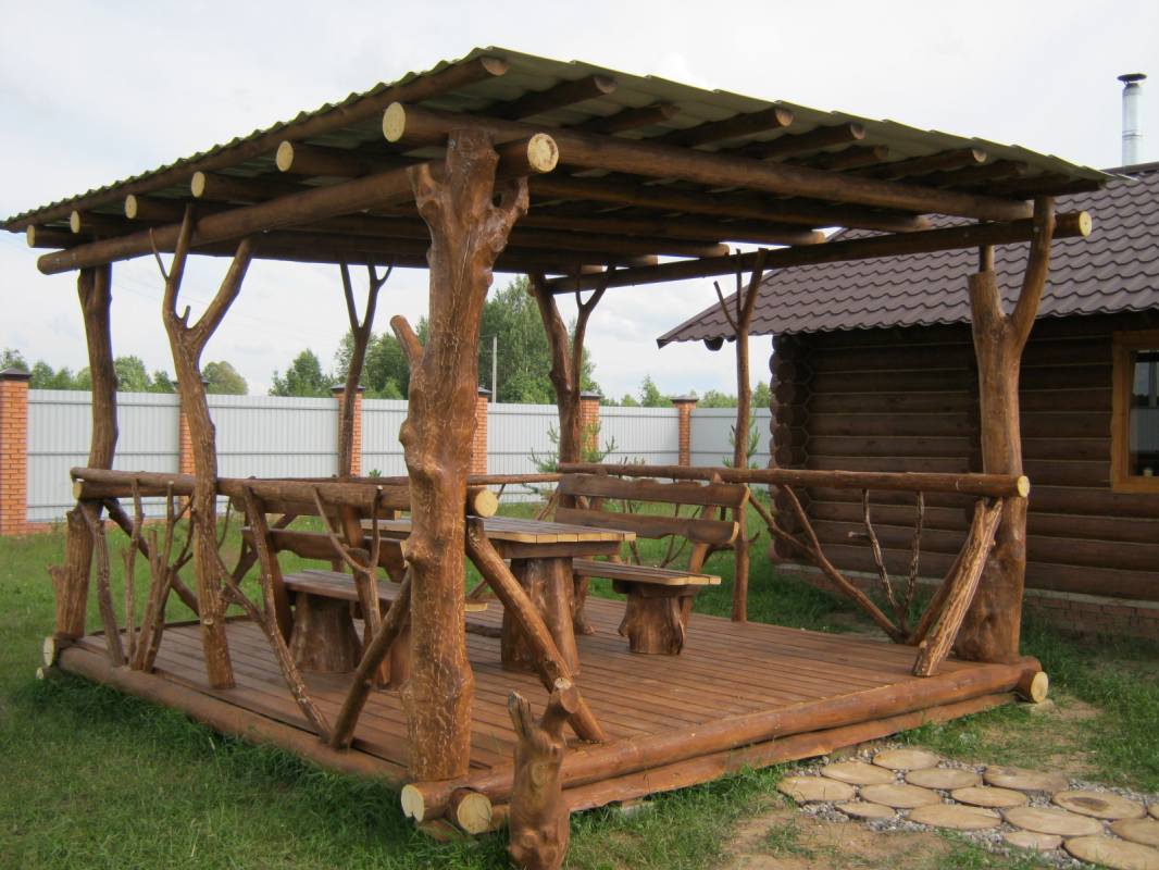 Homemade arbor from the trunks of pine trees