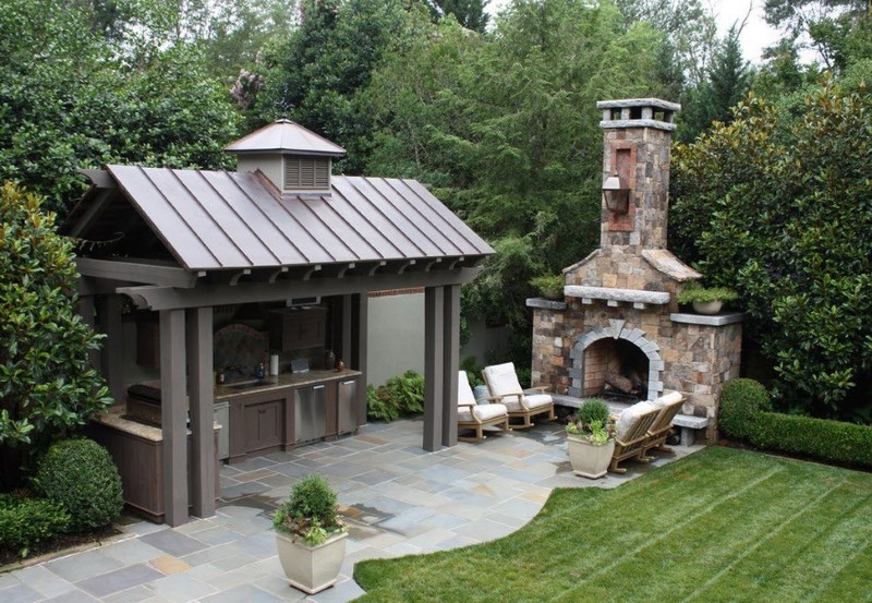 Summer kitchen with fireplace in the garden