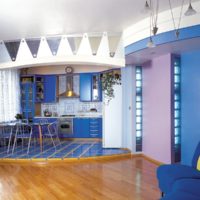 Blue kitchen on the podium and wooden floor