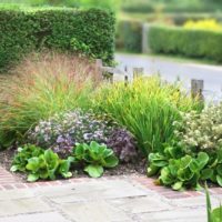 Small flower bed with incense in front of the gate