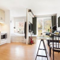 Bed behind the partition in the interior of a studio apartment