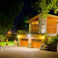 Lighting of the facade of a residential building with garages in the basement