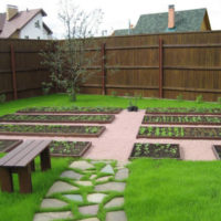 Decorative beds and a wooden fence