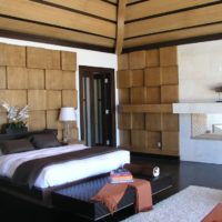 The interior of the bedroom with wood trim walls and ceiling