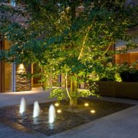 Illuminated fountain in the courtyard of a country house