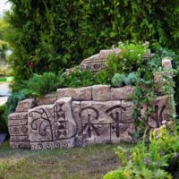 Flowerbed with hieroglyphs in the design of the garden