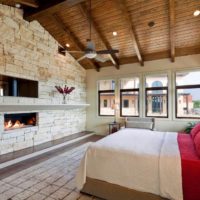 Wooden ceiling and brick wall in bedroom design