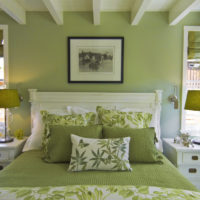 Textiles and walls in olive tones in the design of the bedroom