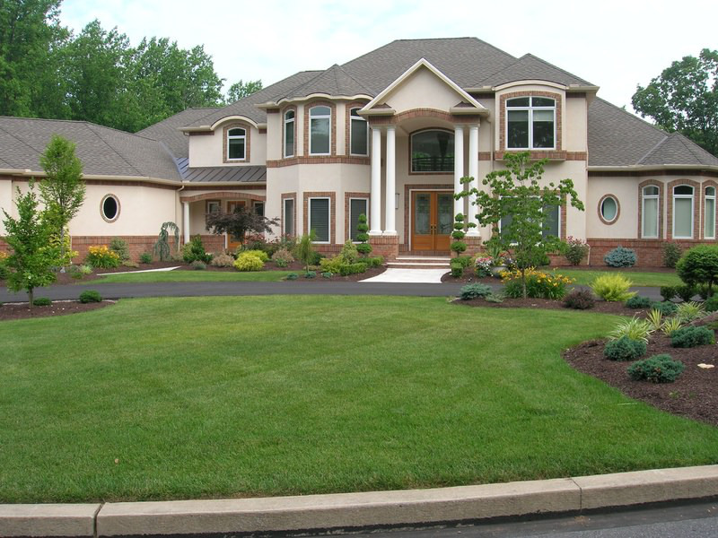 English green lawn in front of the facade of a country house