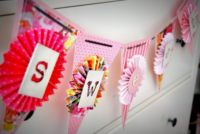 Paper garland on a dresser in a children's room