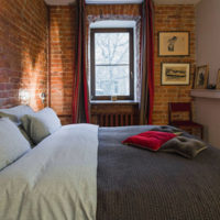 Rough brick wall in the bedroom interior