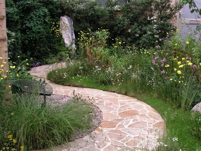 Concrete walkway under stone cladding