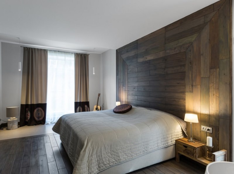 Laminated wall paneling over the bed using mixed styling