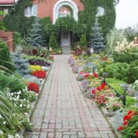 Flower handles along the edges of the paved walkway