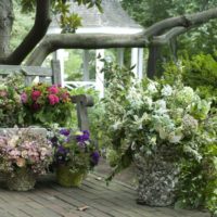 Flowerpots with flowers in landscaping