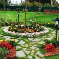 Lanterns on the legs in a flower bed