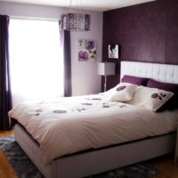 Dark bedroom with a white bedspread on the bed