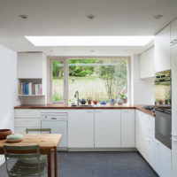 Black linoleum on the floor of a white kitchen