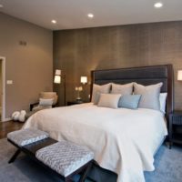 Interior of a dark bedroom with light textiles