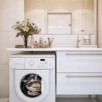 A washing machine and a bouquet of flowers in the bathroom