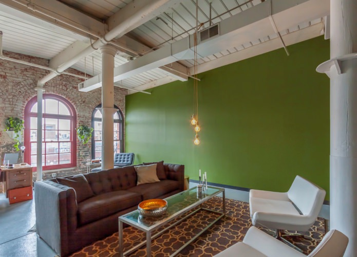 Olive wall in high-ceilinged living room