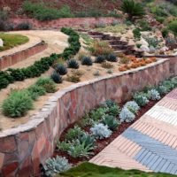 Concrete retaining wall with stone cladding