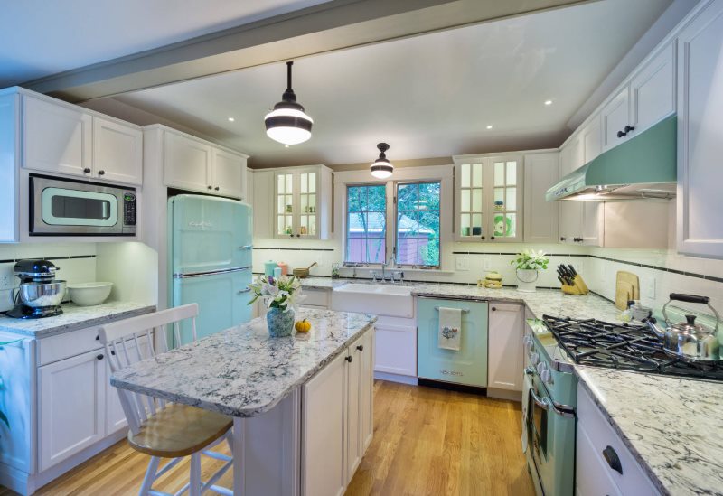 Daisies in vases in a kitchen interior